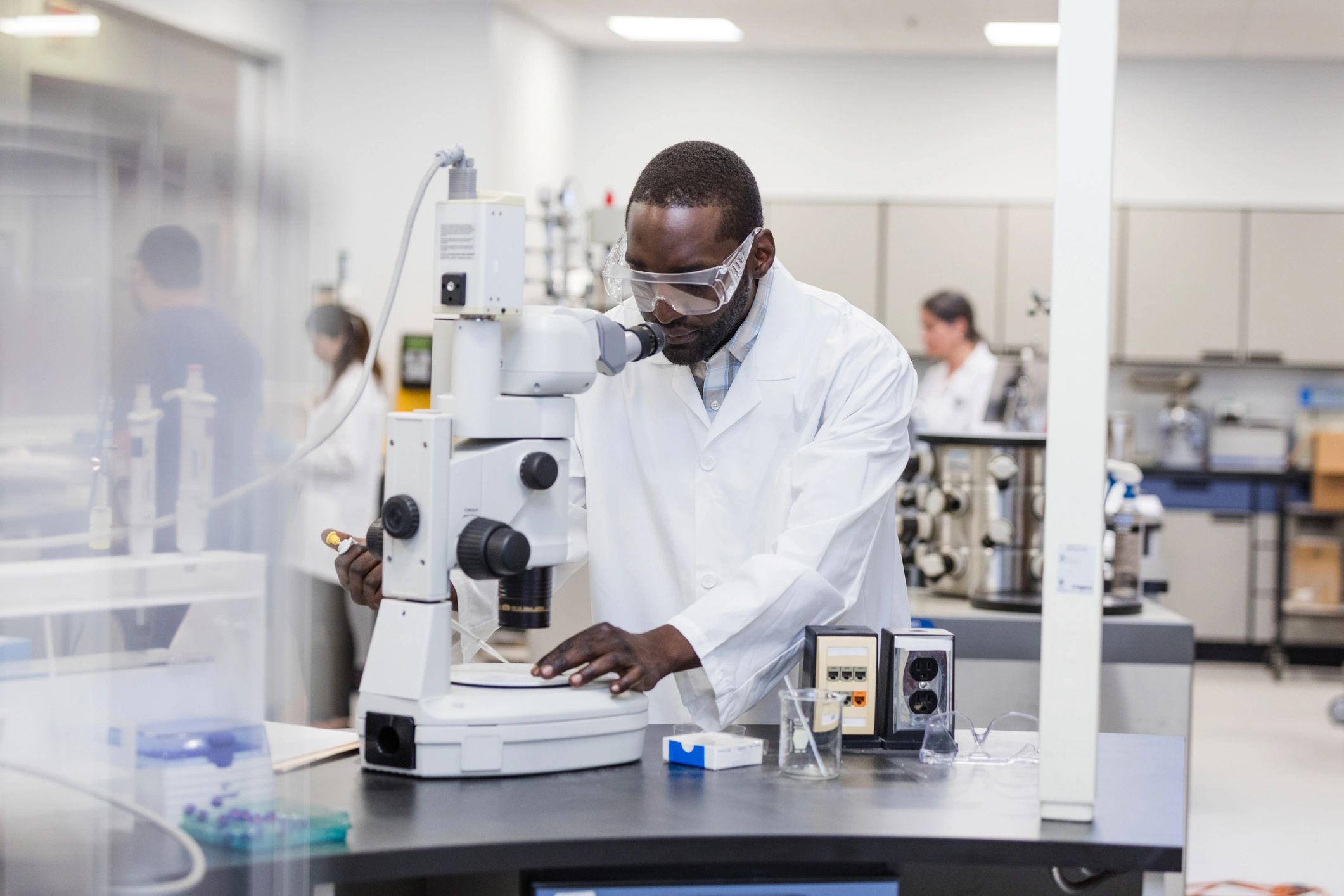Laboratory technician preparing a slide with a pipette
