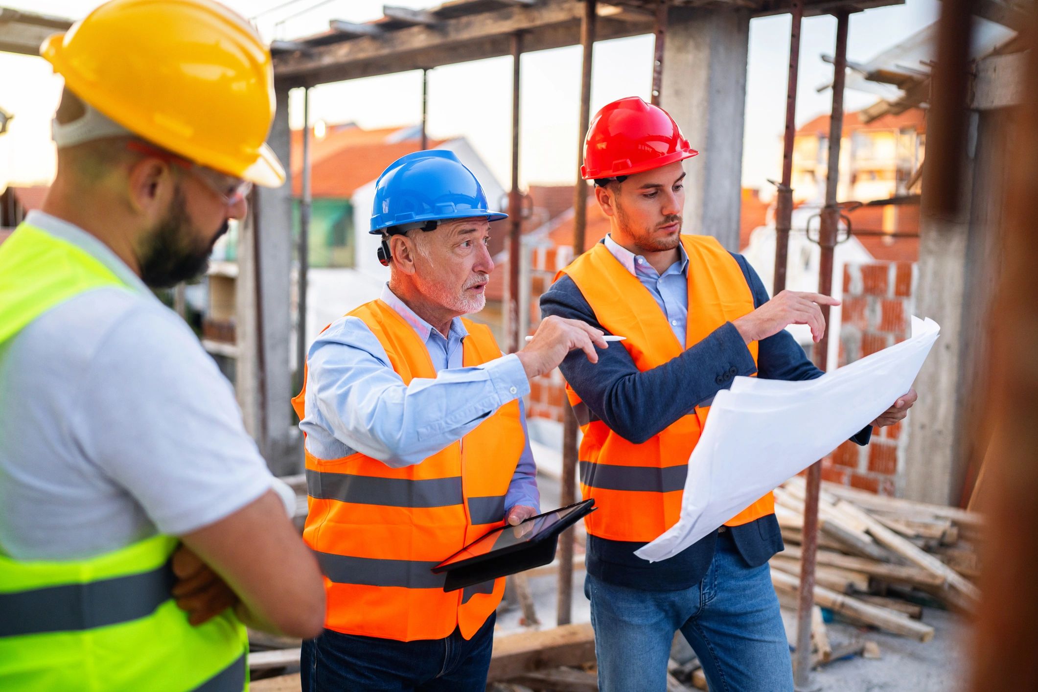 Engineers reviewing a blueprint on a construction site