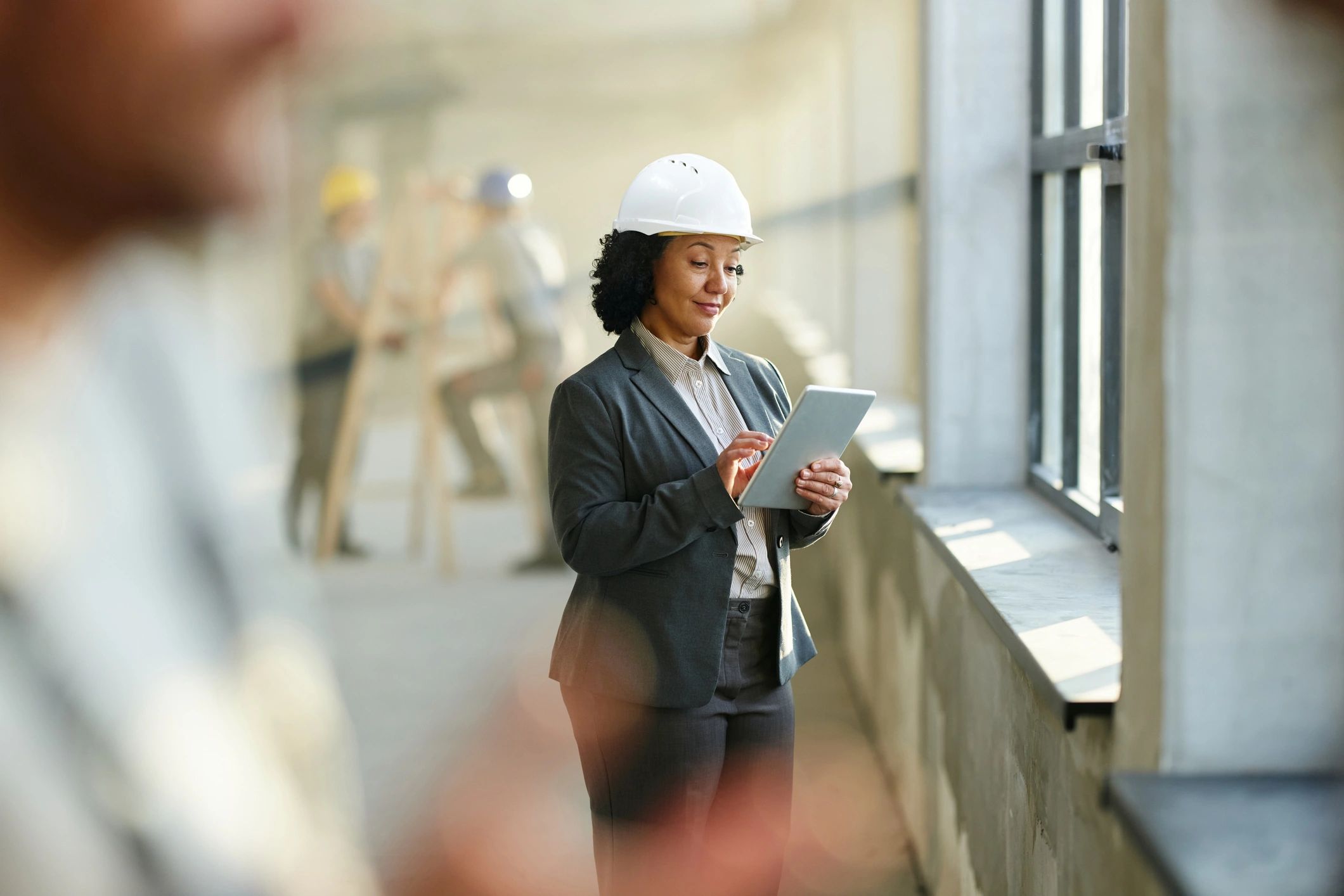 Construction professional using a tablet on site