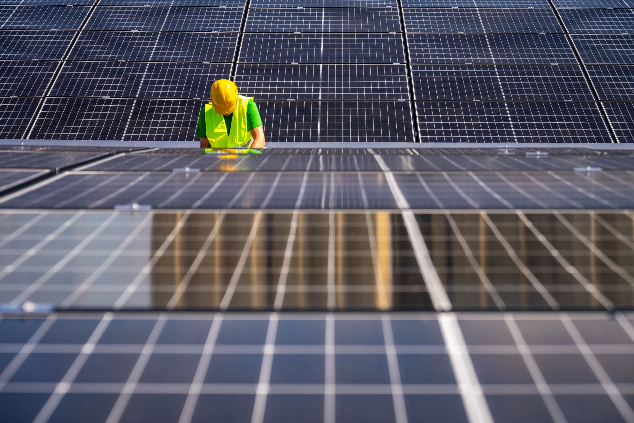 Technician inspecting rooftop solar panels