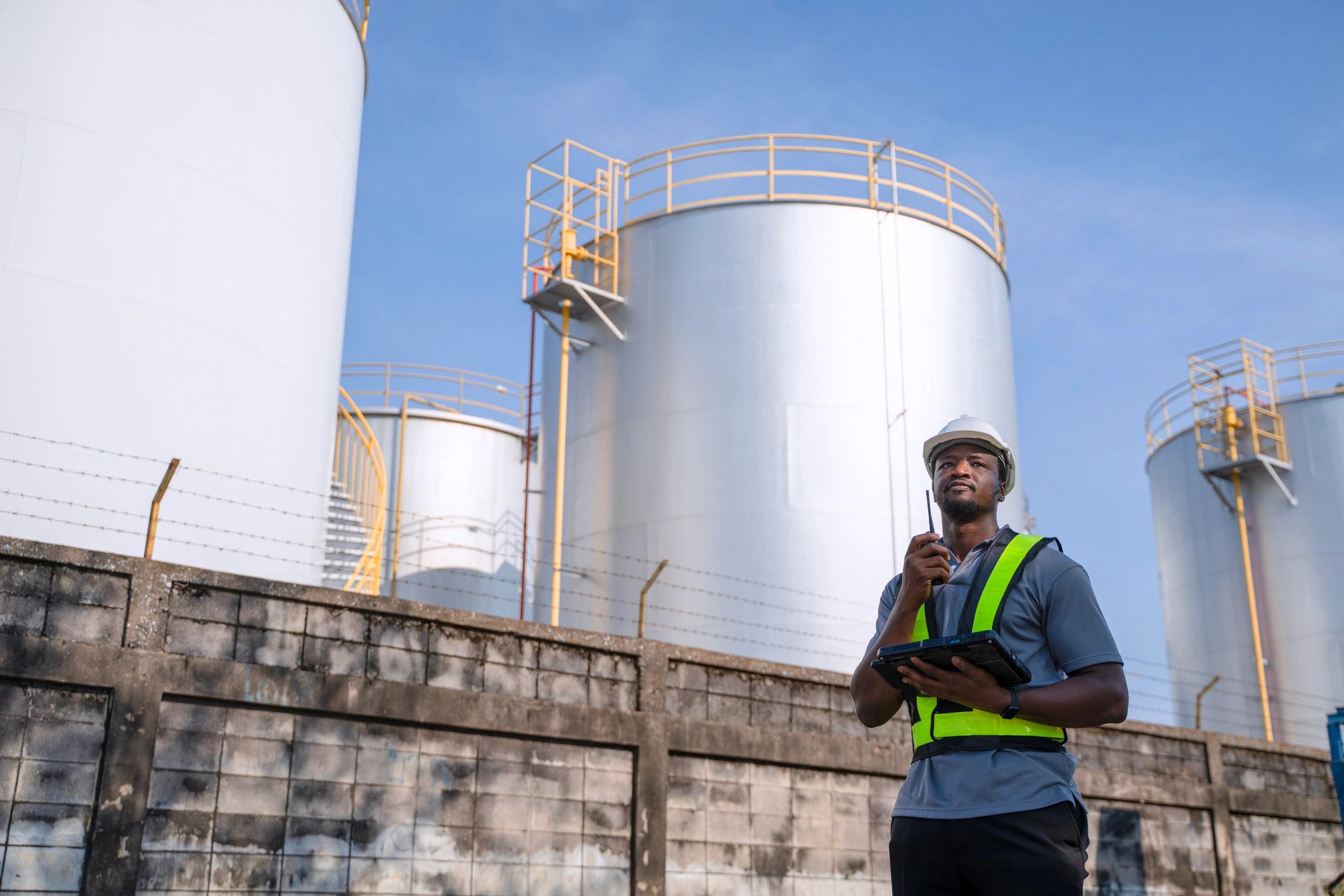Industrial technician inspecting equipment inside a factory